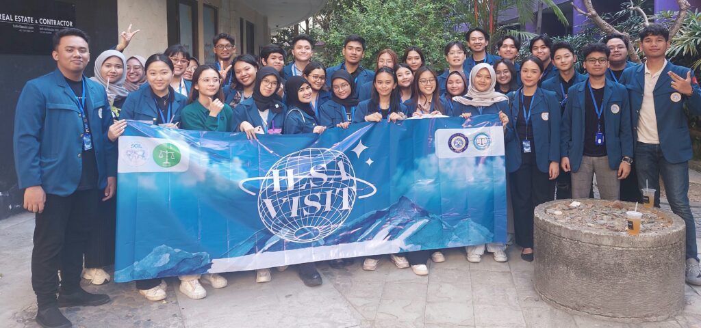 International Law Students Association posing with a sign.