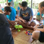 Volunteers playing games with local children and community.