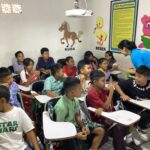 Local children pictured sitting at their desks.
