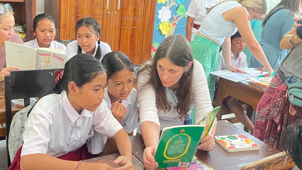Volunteer reading to local children.