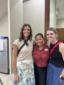 Volunteers and teacher posing for a picture.
