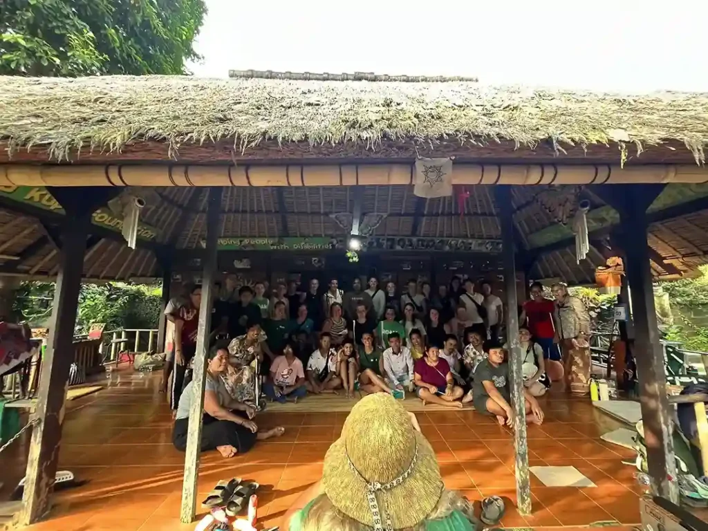 Volunteers posing for a picture under a pavilion together.