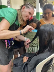 Volunteer giving a child a haircut.