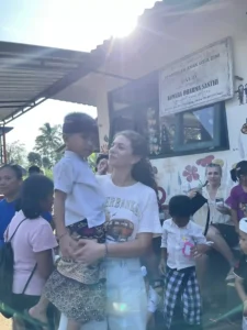Volunteer holding a local child.