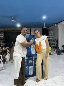 Volunteer and community member posing together for a picture.