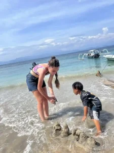 Volunteer playing with a local child in the water.