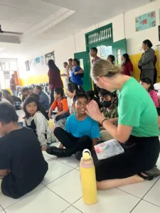 Volunteer talking with a child from the local community.