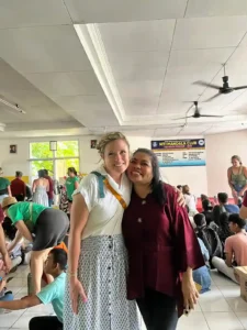 Volunteer and community member posing for a picture together.