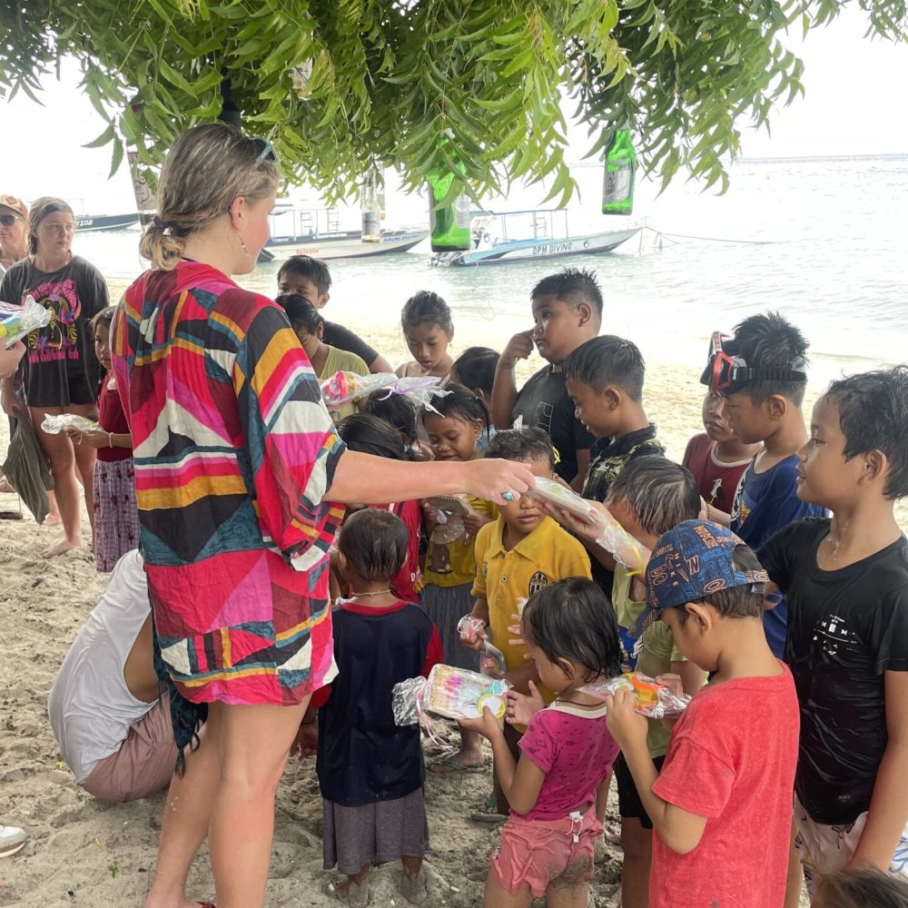 Volunteer handing out gift bags to children