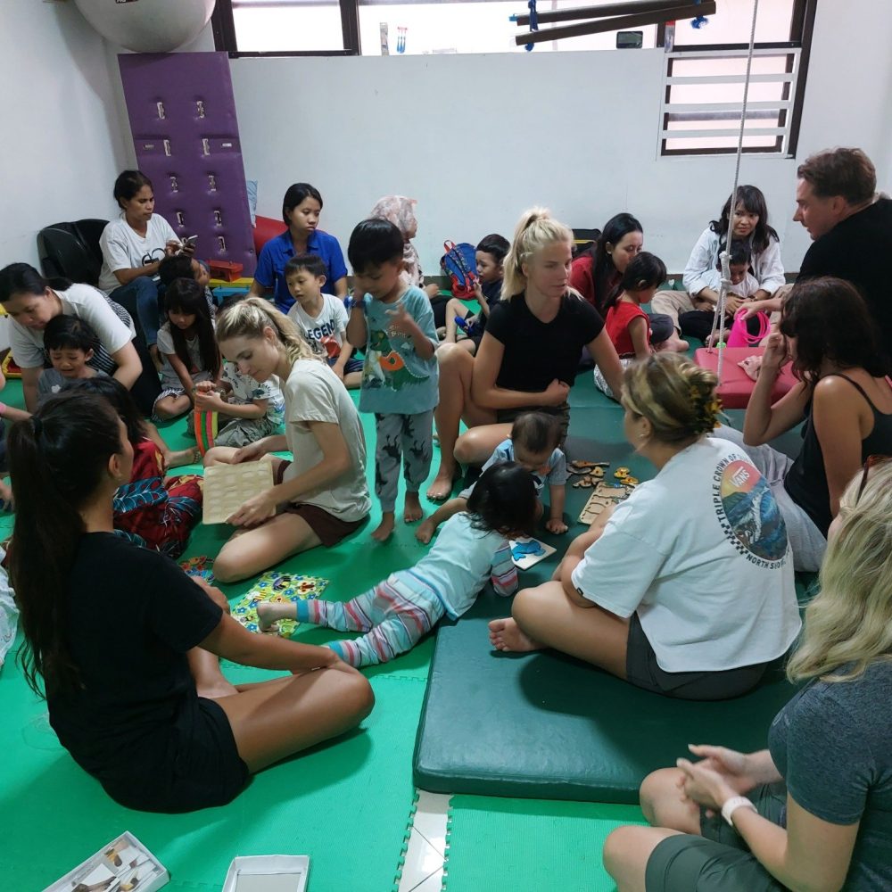 Volunteers playing games with young children.