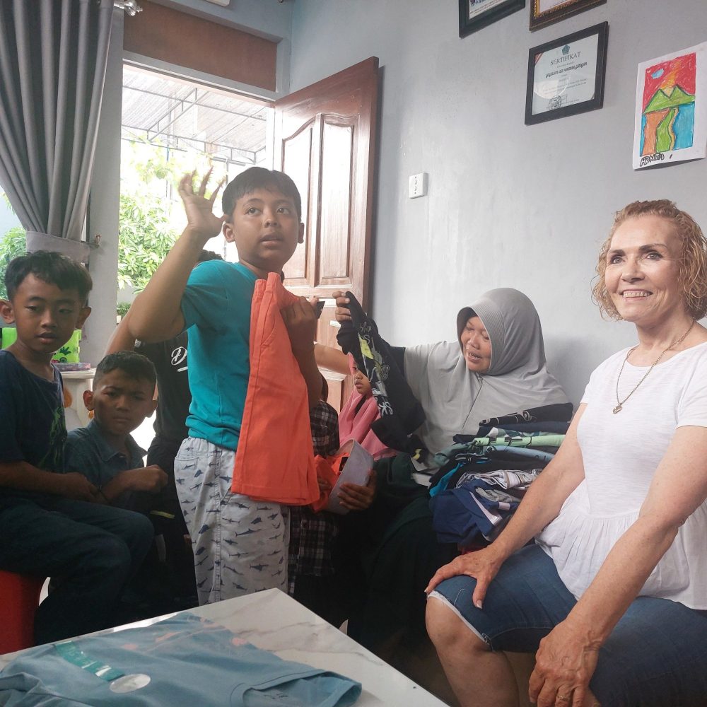 Smiling volunteer with a group of children